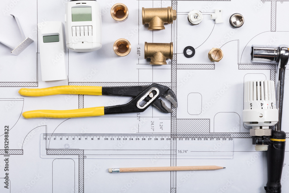 Fototapeta premium Thermostat With Work Tools On Blueprints