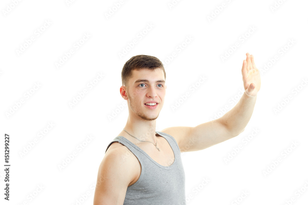 young charming guy raised his hand and shows a gesture young charming guy raised his hand and shows a gesture