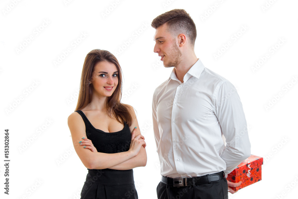 beautiful young girl in a black dress standing next to a guy in a shirt that brought her a gift beautiful young girl in a black dress standing next to a guy in a shirt that brought her a gift