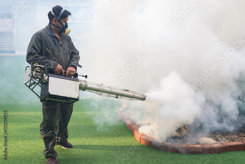 Men are working fogging to eliminate mosquito for preventing spread dengue fever