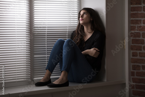 Pensive Woman Sitting By The Window © Andrey Popov