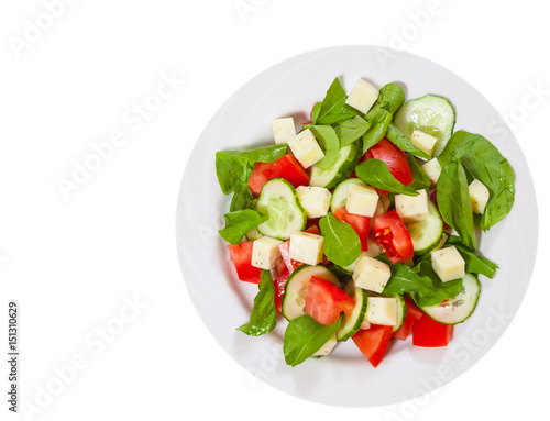 Fresh salad with tomatoes, arugula, cucumber and cheese cubes. top view. isolated on white