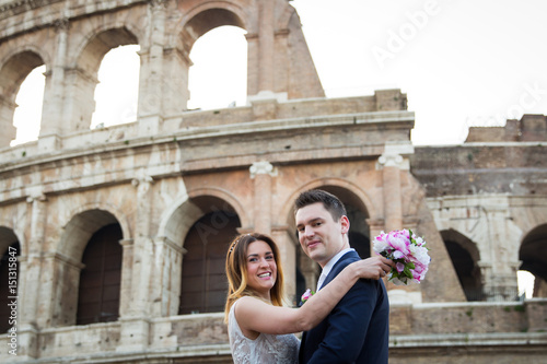 Bride and groom wedding poses in front of Colosseum, Rome, Italy