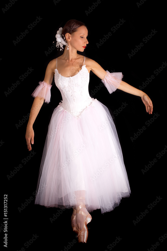 Beautiful ballet dancer posing on black background
