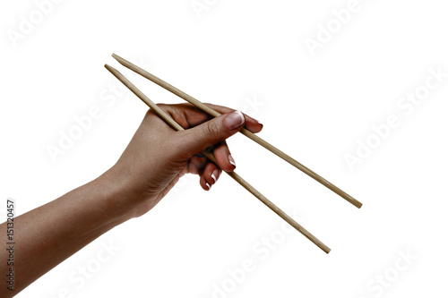 African female hand holds chopsticks on a white background.
