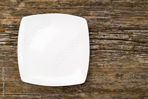 The white square plate on a wooden background 
