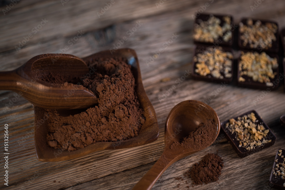 Chocolate bar pieces with cocoa powder. Background with chocolate. Slices of chocolate, Copyspace Chocolate bar pieces with cocoa powder. Background with chocolate. Slices of chocolate, Copyspace