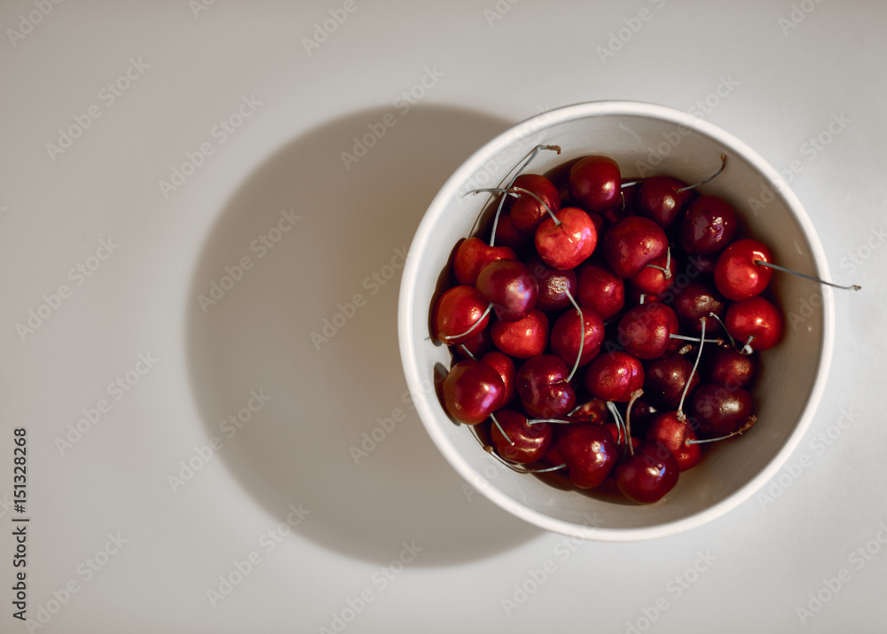 Red Cherries in a Bowl on the White Background