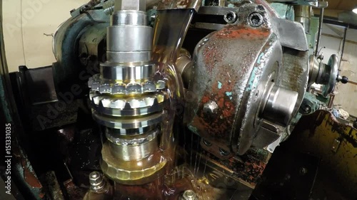 The toothed wheel is produced in the workshop on the machine
