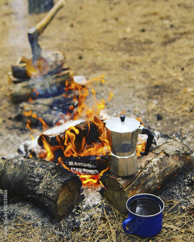 Camping in the forest. Preparation of breakfast at the stake.