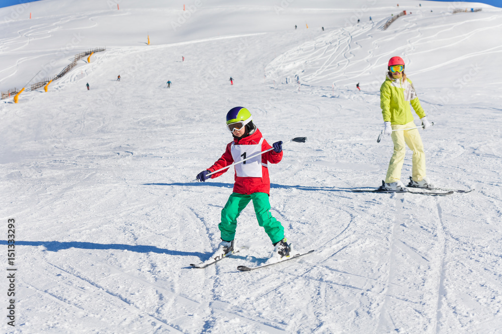 Boy learning downhill skiing with instructor Boy learning downhill skiing with instructor