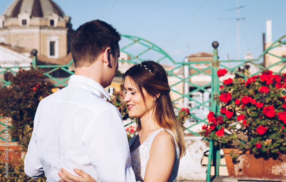 Fototapeta premium Bride and groom dancing on the terrace, Rome, Italy