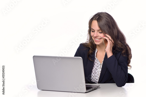 Smiling young girl with laptop on a white background