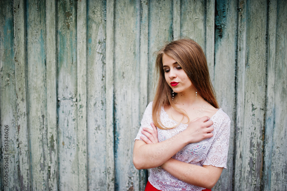 Portrait of beautiful girl with red lips against wooden background, wear on red dress and white blouse. Portrait of beautiful girl with red lips against wooden background, wear on red dress and white blouse.