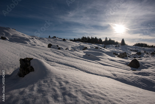 Sunset behind a beautiful winter landscape in the Swiss mountains