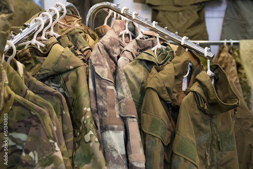 Samples camouflage military clothes in the store photo