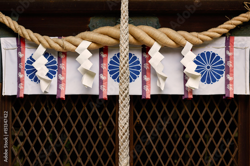 Japanese shinto shrine shimenawa purification rope with shide paper streamers photo