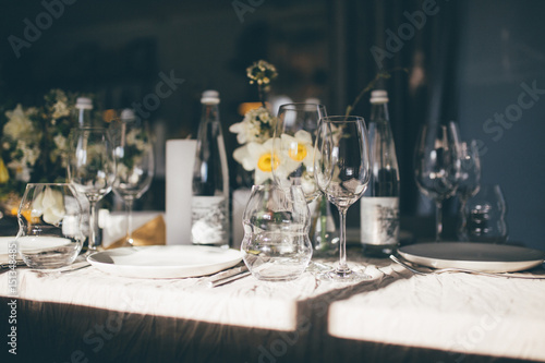 Beautiful served wedding table with decor as candles, flower arrangements. Banquet dinner party © Anton