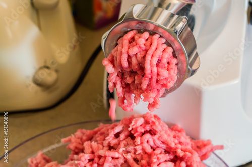 Close-up of minced meat coming out from grinder