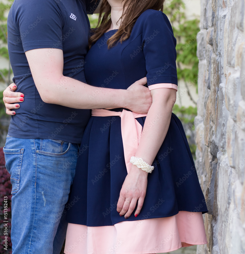 Happy young couple in love at the stone wall Happy young couple in love at the stone wall