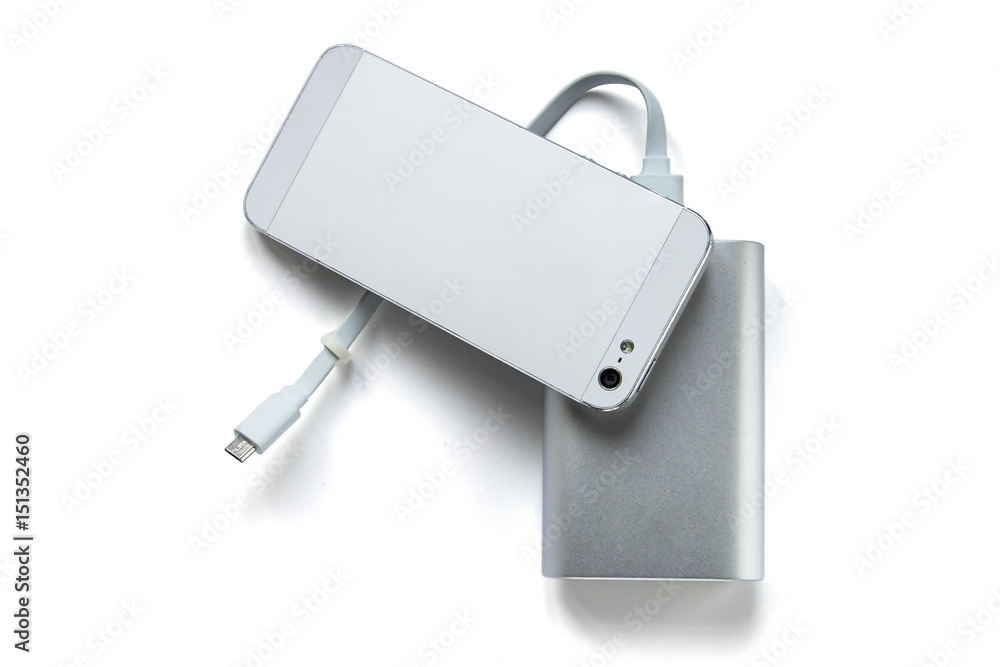 Grey power bank ( portable external battery ) with smartphone on white background Grey power bank ( portable external battery ) with smartphone on white background