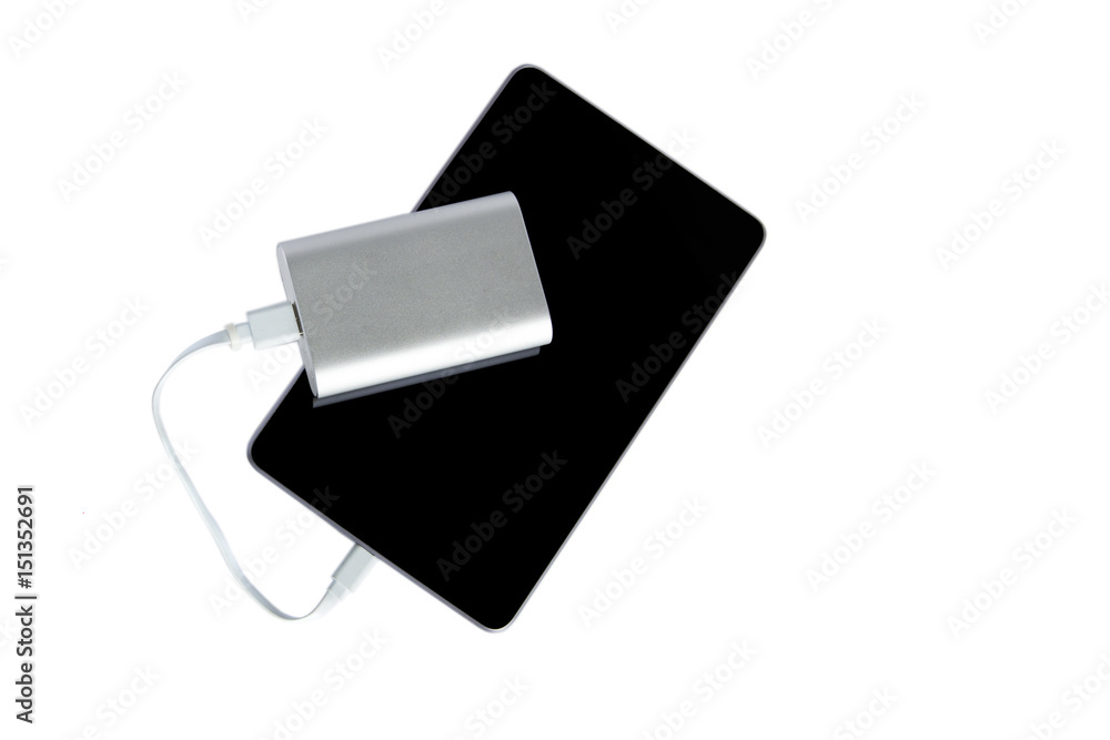 Power bank charging the tablet isolated on a white background Power bank charging the tablet isolated on a white background