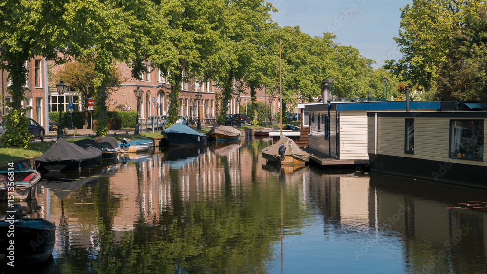 Netherlands, Leiden at the Jan van Goyenkade with houseboats and regular boats resting in the canal on a bright sunny spring day 12 May 2017