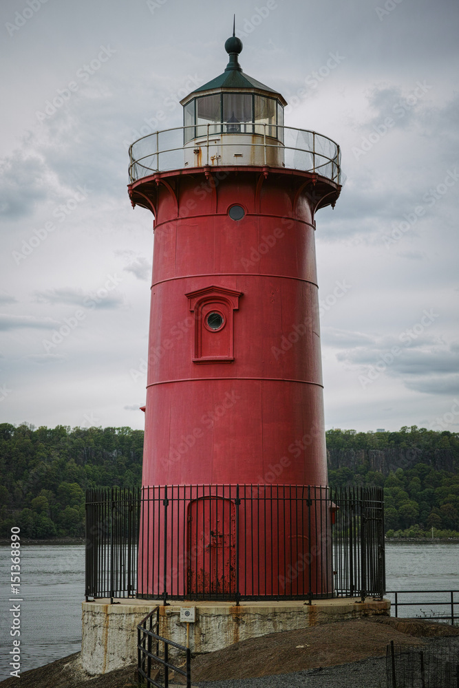 Little red lighthouse under Washington Bridge on overcast day
