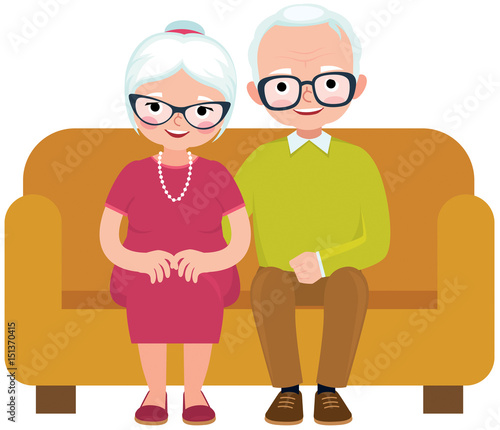 Elderly couple husband and wife sitting on couch embracing