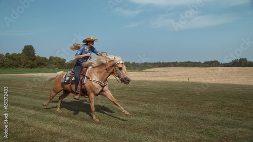 Woman horseback riding in slow motion photo