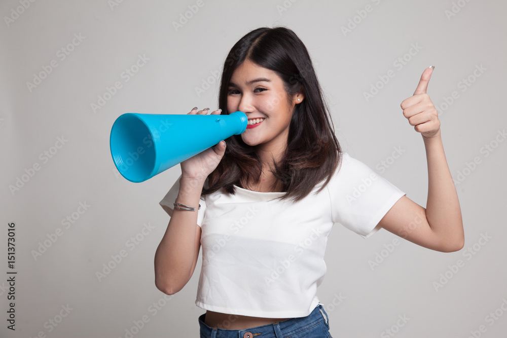 Beautiful young Asian woman show thumbs up announce with megaphone. Beautiful young Asian woman show thumbs up announce with megaphone.