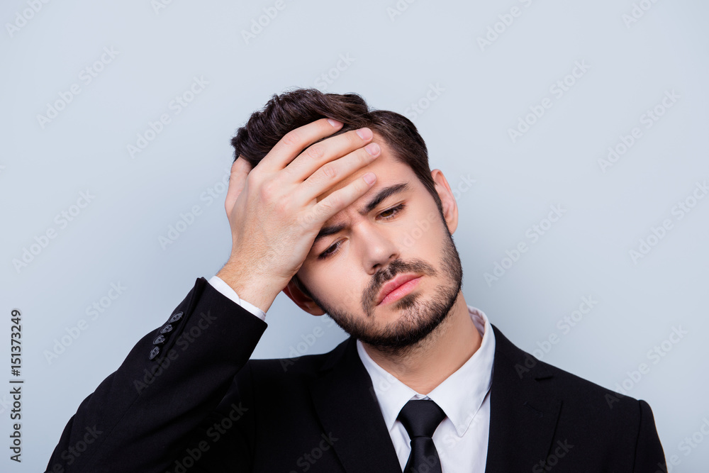 Close up portrait of troubled unhappy man in formal-wear touching his forehead because of having high temperature Close up portrait of troubled unhappy man in formal-wear touching his forehead because of having high temperature