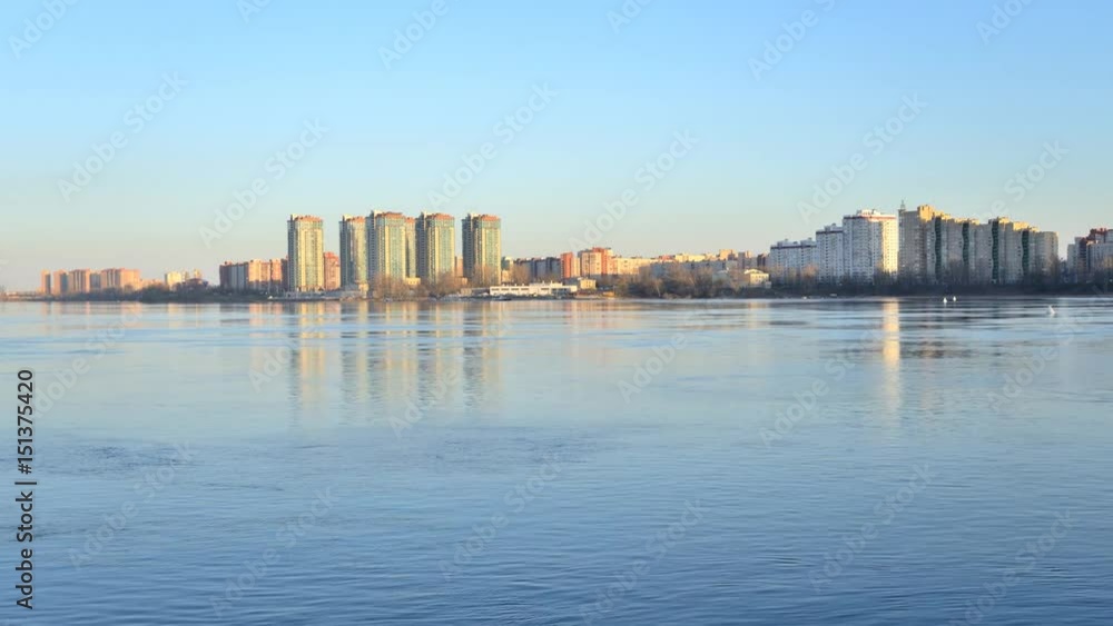 View of Neva river and microdistrict Ribatskoe on the outskirts of St. Petersburg, Russia. Timelapse 4K. Slight fluctuations of camera due to windy weather. View of Neva river and microdistrict Ribatskoe on the outskirts of St. Petersburg, Russia. Timelapse 4K. Slight fluctuations of camera due to windy weather.