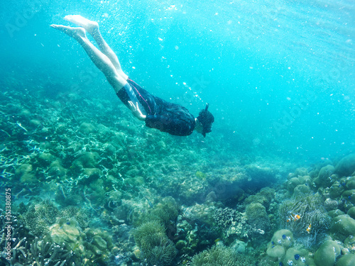 Man dives in a tropical sea
