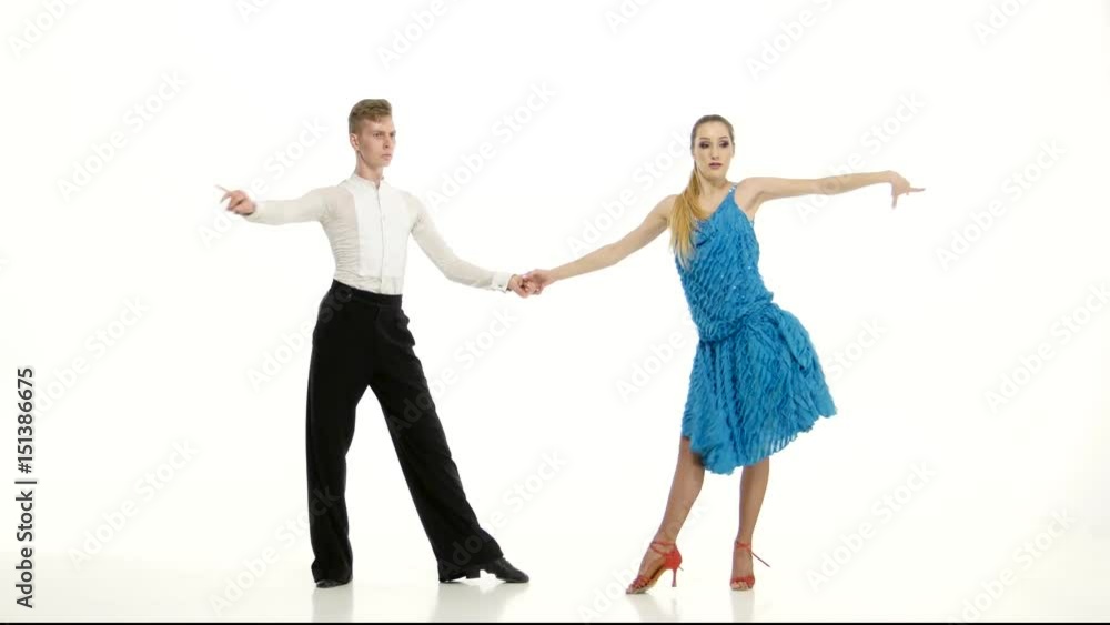 Couple of professional dancers perform samba on white studio background Couple of professional dancers perform samba on white studio background
