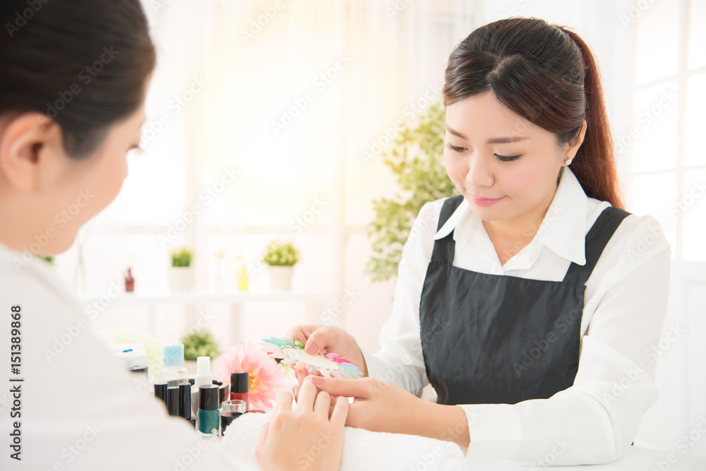 manicurist showing color shellac nail polish