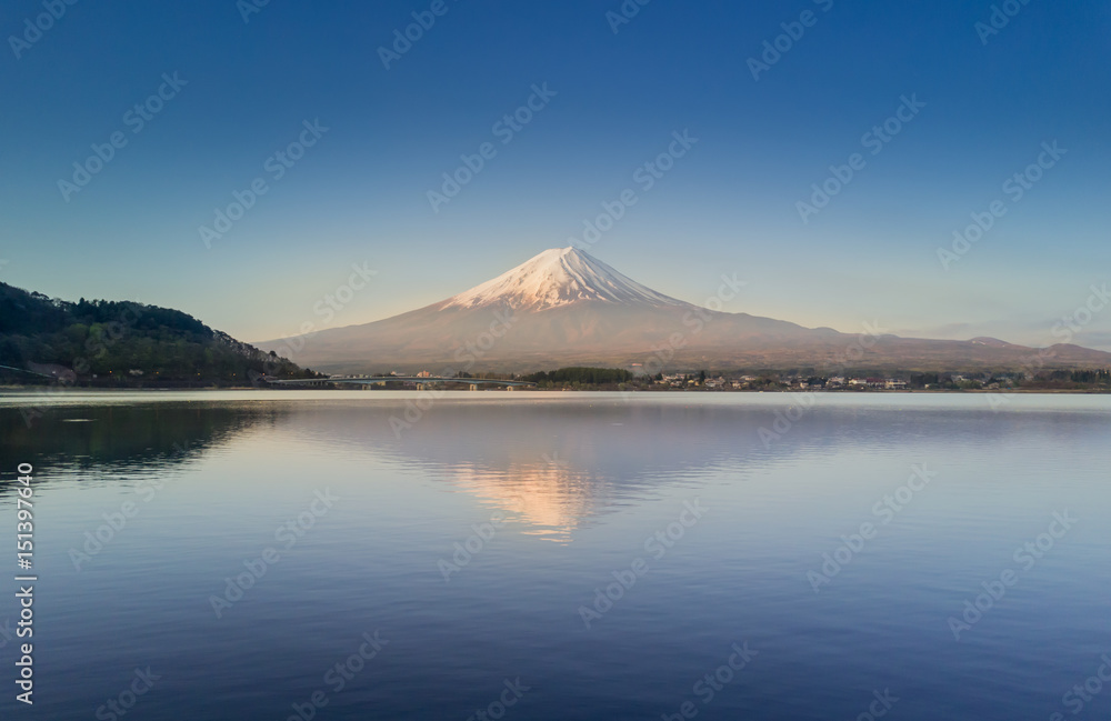 Mountain Fuji reflected in Kawaguchiko lake on a sunny day and clear sky