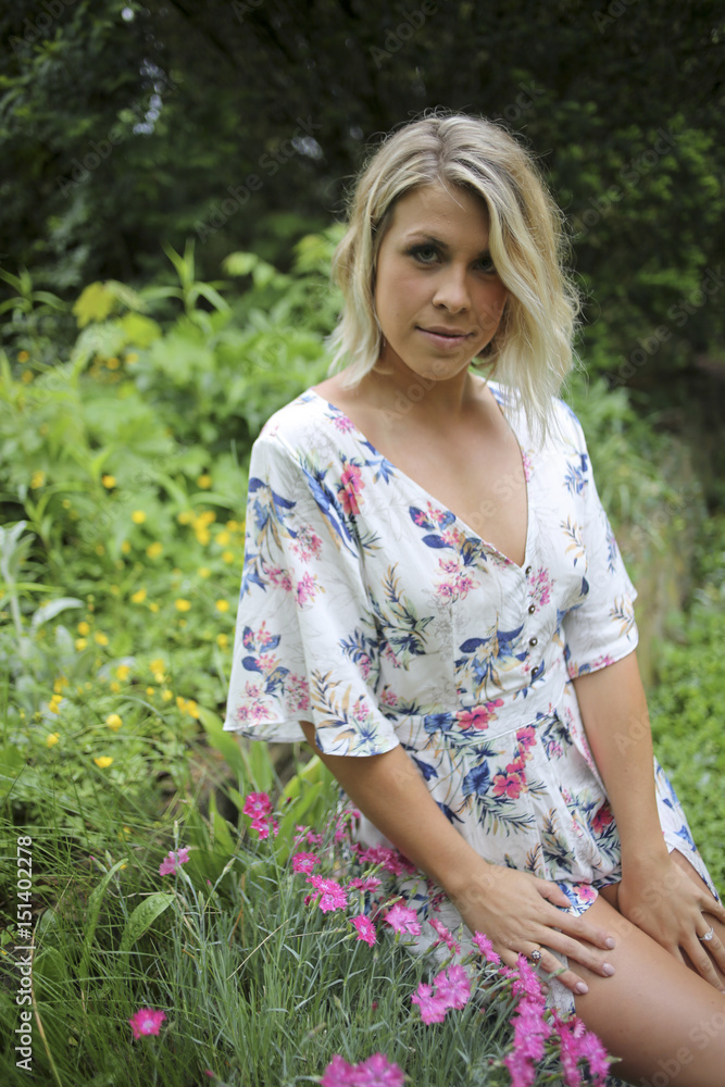 Beautiful Happy Blonde Female in a Floral Dress Romper Beautiful Happy Blonde Female in a Floral Dress Romper