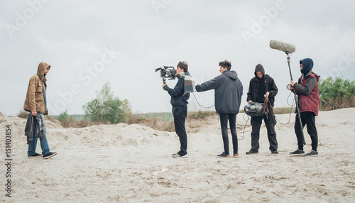 Fotografia, Obraz Behind the scene. Film crew filming movie scene outdoor