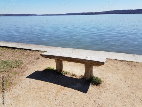 wood bench on side of river