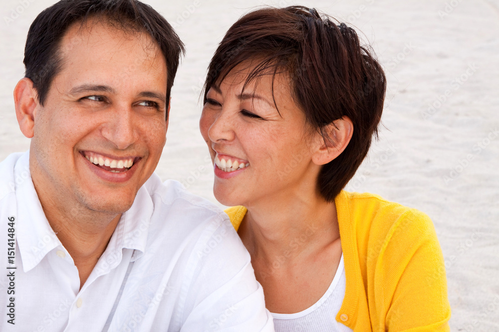Happy couple laughing and talking at the beach. Happy couple laughing and talking at the beach.