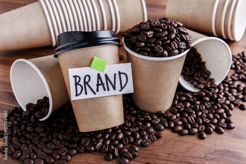 Coffee identity brand building concept with coffee beans and lots of paper coffee cups background