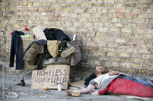 Sad homeless man with  cardboard,  sleep . Social problem
