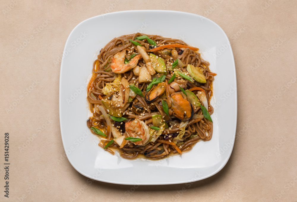 buckwheat noodles with seafood on white plate in restaurant buckwheat noodles with seafood on white plate in restaurant