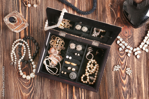 Jewelry accessories in box and table, top view photo