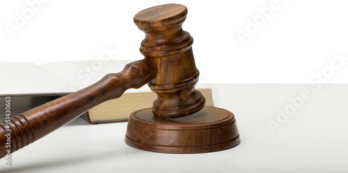 Wooden gavel and books on wooden table