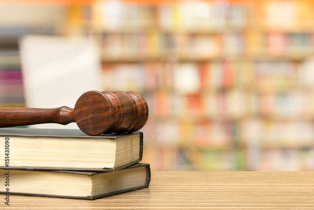Wooden gavel and books on wooden table Wooden gavel and books on wooden table