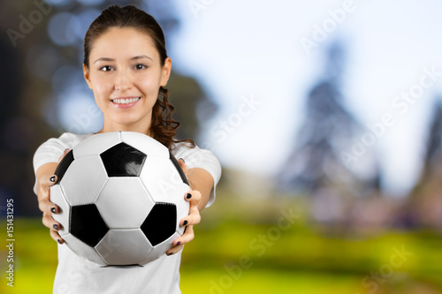 young woman holding soccer ball on her hand © fotofabrika