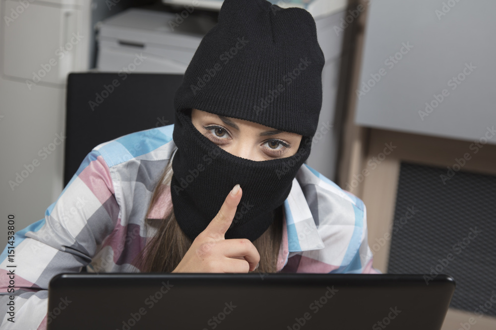 Data thief on computer performs a silent gesture Data thief on computer performs a silent gesture