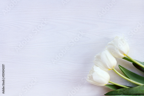  bouquet of flowers for a holiday/ Flat lay with three tulips on a wooden background top view